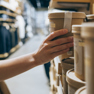 Someone's hand grabbing sustainably packaged product off the shelf