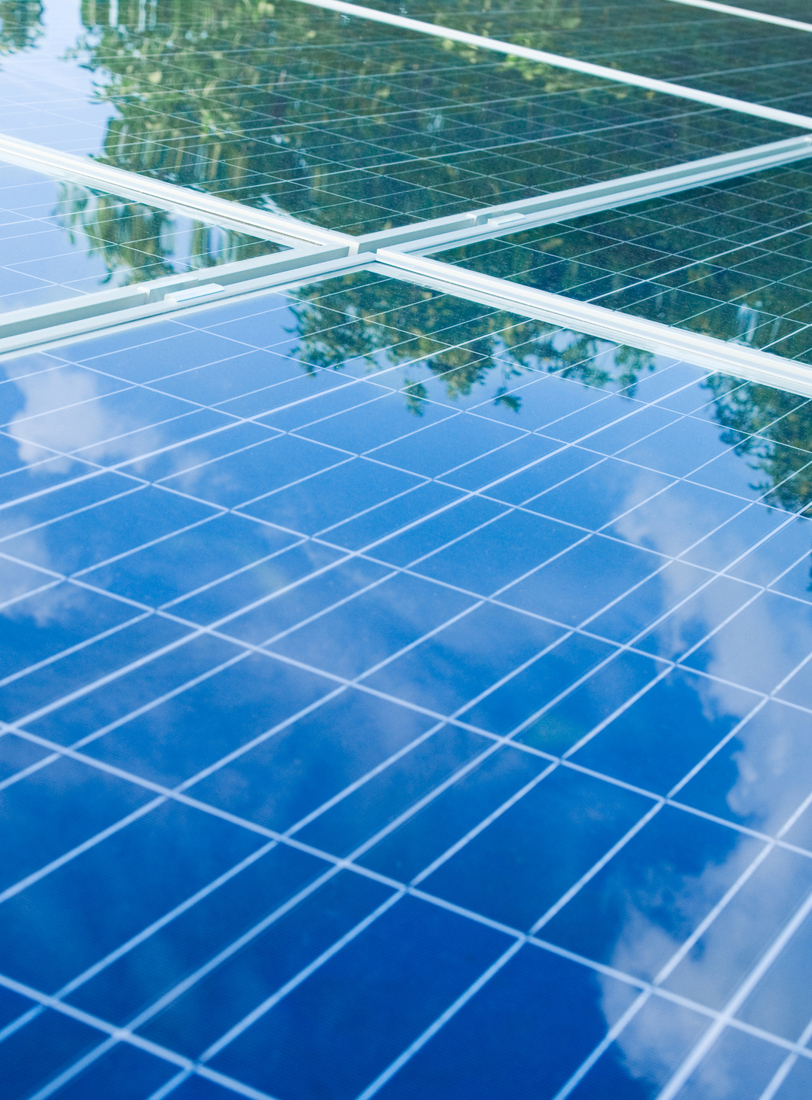 Solar Panels showing reflection of the sky with clouds