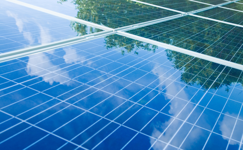 Solar Panels showing reflection of the sky with clouds