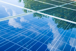 Solar Panels showing reflection of the sky with clouds